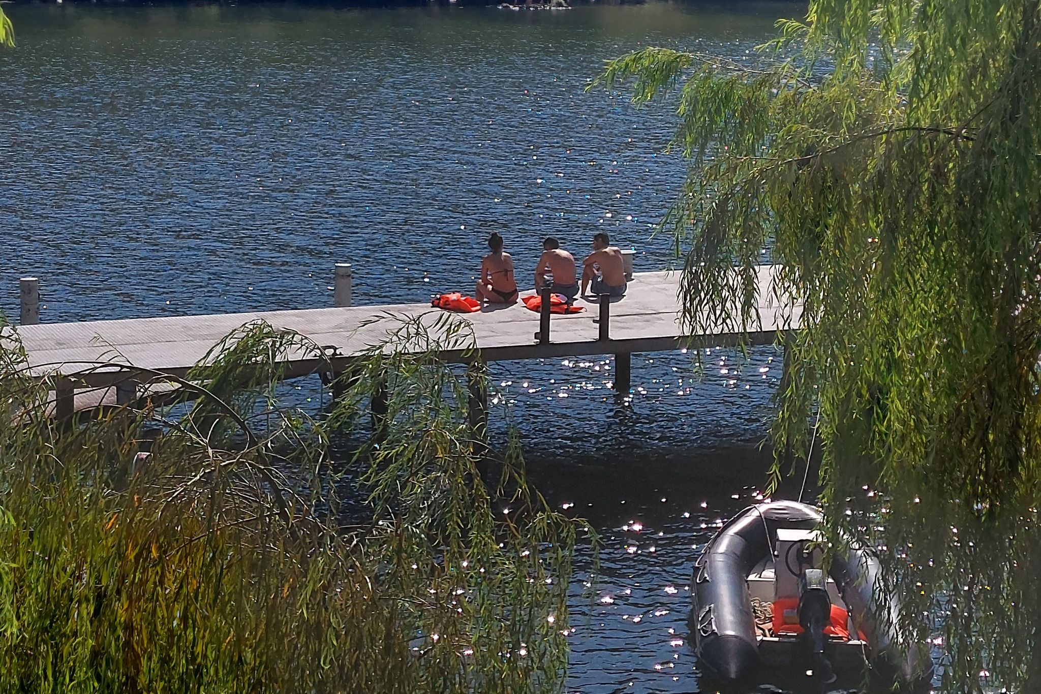 Tua River and pier with 3 sun-bathing young people